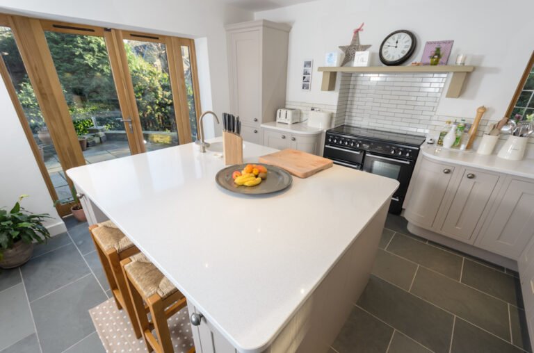 Shaker kitchen with range cooker, white island and garden doors