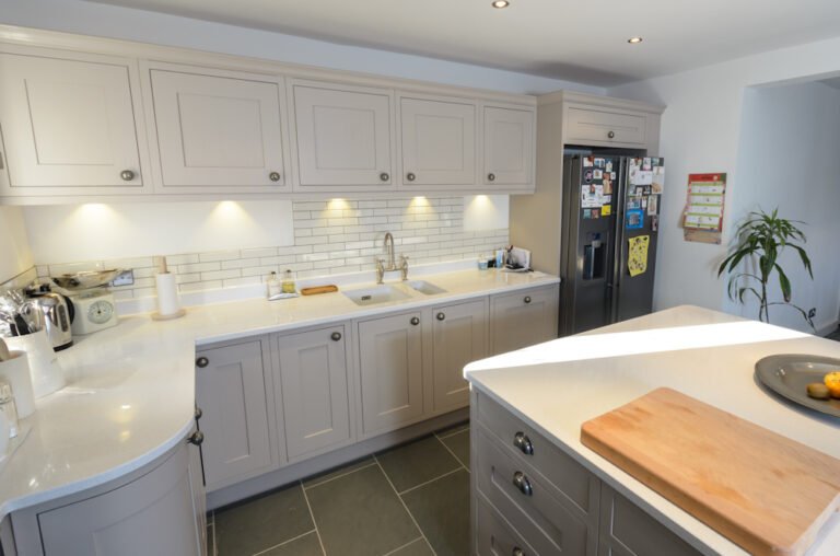 Grey shaker kitchen with metro tile splashback and white quartz island