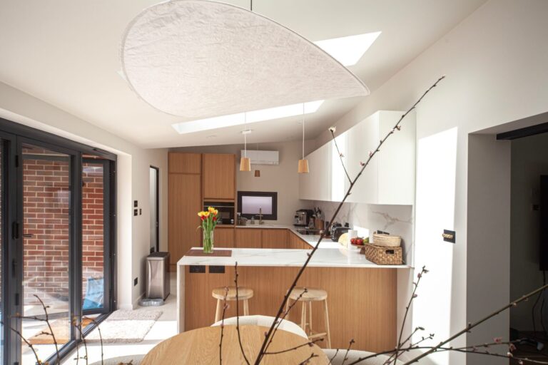 Oak and white kitchen in a rear extension with bifold doors