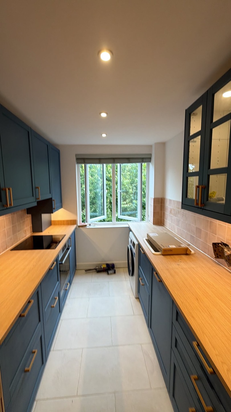 Blue shaker IKEA kitchen with oak larder units, Battersea